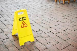 caution wet floor sign on the floor photo