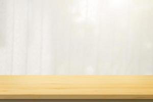Empty wood table top with window curtain blur background for product display photo