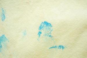 dirty color stain on yellow fabric texture background photo