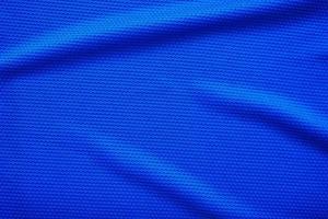 Blue football jersey clothing fabric texture sports wear background, close up top view photo