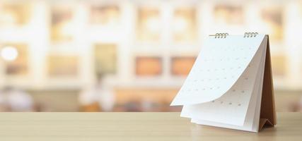 desk calendar on table with blurred bokeh background appointment and business meeting concept photo