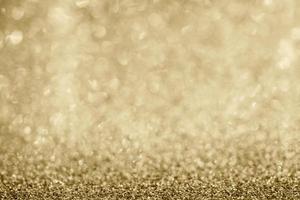Abstract gold glitter sparkle blurred with bokeh background photo