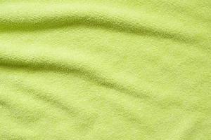 Green towel fabric texture surface close up background photo