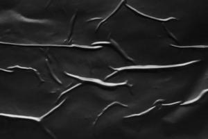 fondo de textura de cartel de plástico negro arrugado y arrugado foto