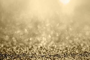 Abstract gold glitter sparkle blurred with bokeh background photo