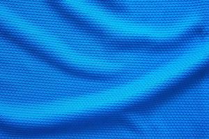 Blue football jersey clothing fabric texture sports wear background, close up top view photo