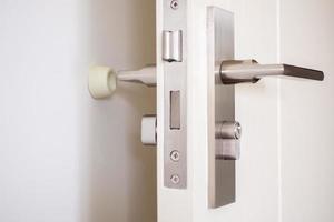 Wall mounted door stopper with modern door handle photo