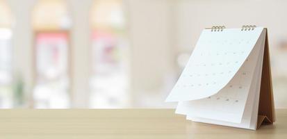 desk calendar on table with blurred bokeh background appointment and business meeting concept photo