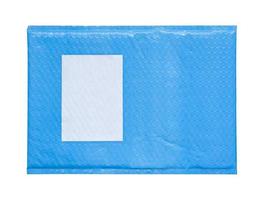 blue plastic wrap air bubble packaging envelope with blank label sticker isolated on white background photo