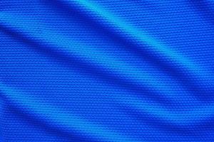 Blue football jersey clothing fabric texture sports wear background, close up top view photo