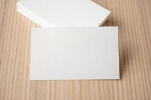 White business card on wood table background photo