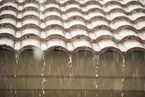 rain falling down from the house roof photo