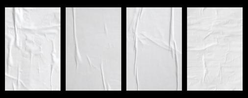 white crumpled and creased glued paper poster set isolated on black background photo