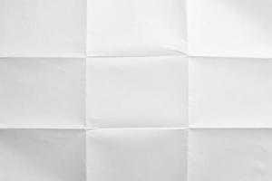 White folded and wrinkled paper texture background photo