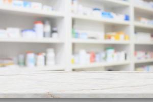 Empty white marble counter top with blur pharmacy drugstore shelves background photo