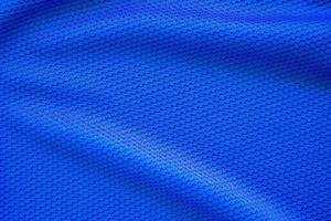 Blue football jersey clothing fabric texture sports wear background, close up top view photo