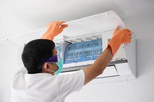 Asian man hand hold air conditioner filter cleaning concept photo