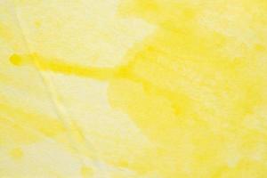 Abstract yellow watercolor background texture close up photo