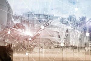 Blockchain network on blurred skyscrapers background. Financial technology and communication concept photo
