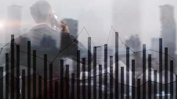 Business people silhouettes with forex chart on blurry city background. Teamwork, finance and success concept. Mixed Media. photo