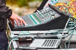 Sound engineer hands working on sound mixer at live concert, stage sound mixer, audio mix slider photo