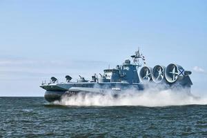 Landing Craft Air Cushion hovercraft flying above water, air cushion sailing splashing sea water photo