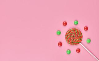 Sweet lollipop and candy on pink background photo