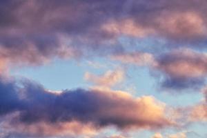 Fluffy cumulus purple and pink clouds, cloudscape photo