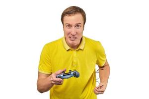Funny man gamer with gamepad and glasses isolated on white background, excited video game player photo