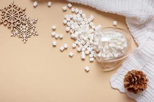 Christmas hugge flat lay composition with cup of marsh mellow, snowflakes top view photo