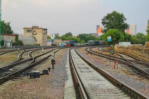 Railway line junction tracks. Railroad travel, tourism.Transportation concept. Iron detail over dark stones. Heavy industrial landscape. Technology modern infrastructure development. Close up photo