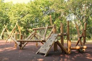 Wooden modern ecological safety children outdoor playground equipment in public park. Nature architecture construction playhouse in city. Children rest and childhood concept. Idea for games on air. photo