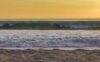 Colorful golden sunset big wave and beach Puerto Escondido Mexico. photo