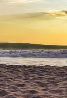 Colorful golden sunset big wave and beach Puerto Escondido Mexico. photo