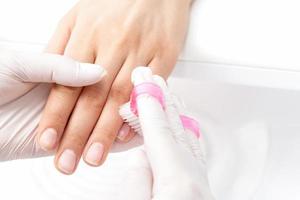 Manicure master removes dust. photo
