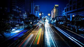 la luz de los autos corriendo uno contra el otro con un obturador bajo en medio de la capital bangkok tailandia foto