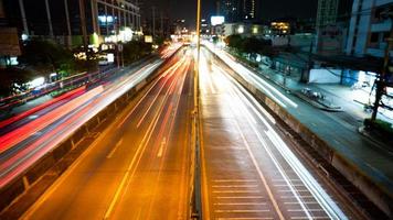 The light of cars running against each other with a low shutter shot in the middle of the capital Bangkok Thailand photo
