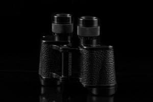 old vintage binoculars isolated on black background, travel concept. photo