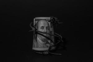 Dollar banknote with barbed wire, Economic crisis, background effect with little noise photo