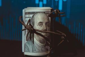 Dollar banknote with barbed wire, Economic crisis, background effect with little noise photo