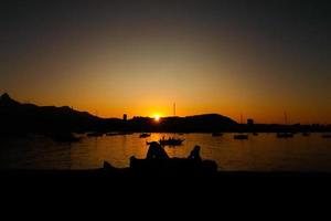 Rio de Janeiro, RJ, Brazil, 2022 - Sunset at district of Urca, traditional neighborhood in Rio de Janeiro - girl in silhouette photo