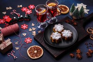 Hot mulled wine with a slice of orange, with cinnamon, cloves and other spices photo