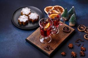 Hot mulled wine with a slice of orange, with cinnamon, cloves and other spices photo