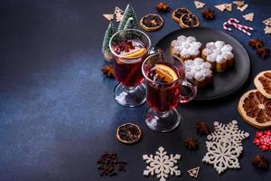 Hot mulled wine with a slice of orange, with cinnamon, cloves and other spices photo