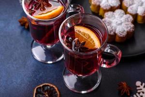 Hot mulled wine with a slice of orange, with cinnamon, cloves and other spices photo