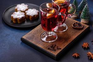 Hot mulled wine with a slice of orange, with cinnamon, cloves and other spices photo