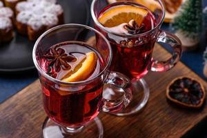 Hot mulled wine with a slice of orange, with cinnamon, cloves and other spices photo