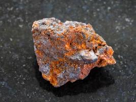 rough Hematite iron ore stone on dark photo