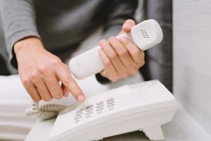 On the phone home  Young man calling talking on the telephone while lying bedroom on home. photo