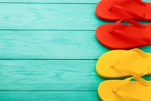 flip flops on blue wooden background with copy space. Top view. Mock up. Summer shoes sandals. Slippers photo